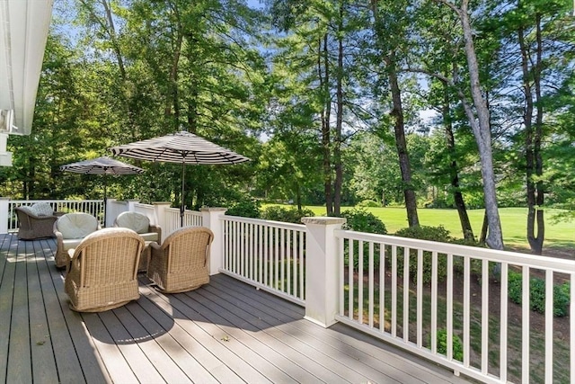 wooden terrace featuring a lawn