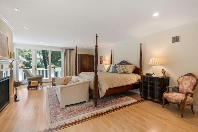 bedroom with ornamental molding, access to exterior, and light hardwood / wood-style floors