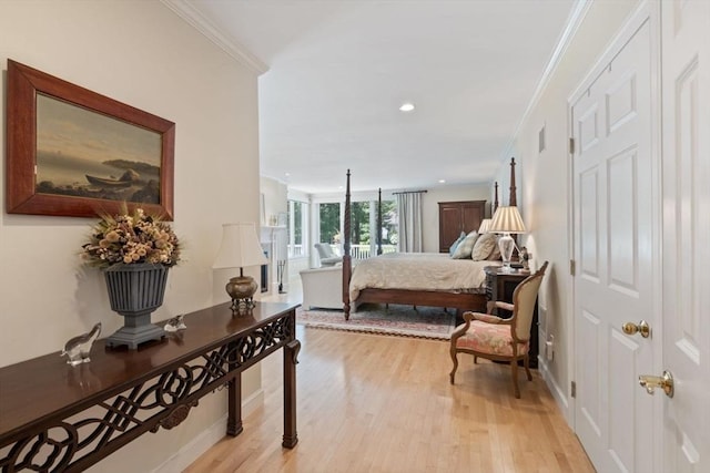 bedroom featuring crown molding and light wood-type flooring