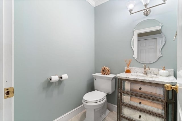 bathroom featuring ornamental molding, toilet, and vanity