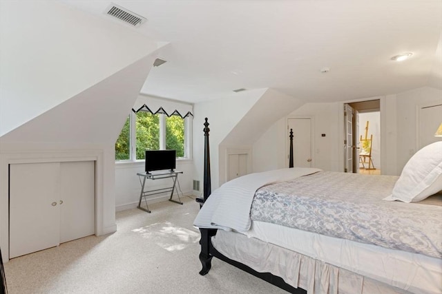 carpeted bedroom featuring vaulted ceiling