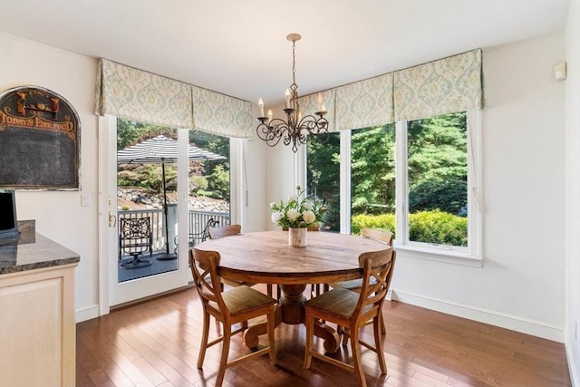 dining room featuring a notable chandelier and dark hardwood / wood-style flooring