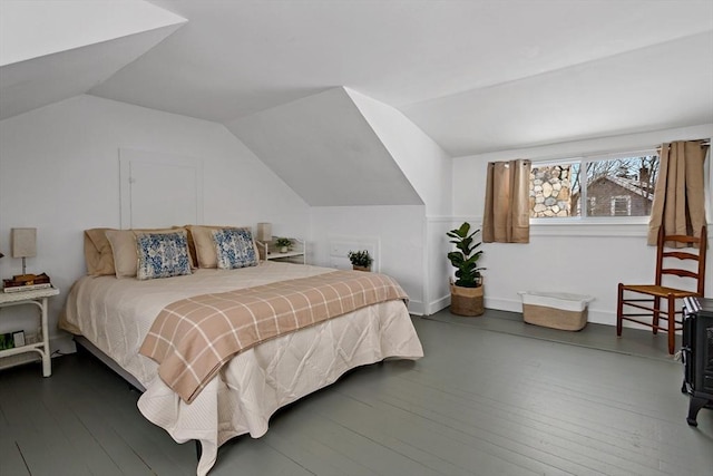 bedroom with vaulted ceiling and dark hardwood / wood-style floors