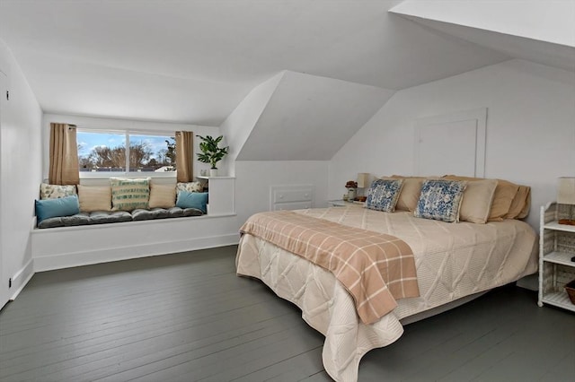 bedroom with vaulted ceiling and dark hardwood / wood-style floors