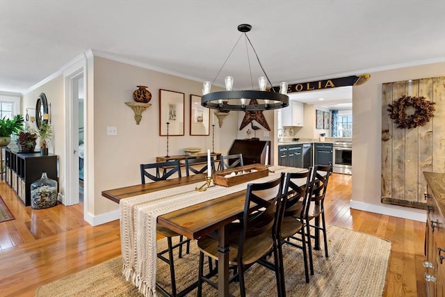 dining space with crown molding and light wood-type flooring