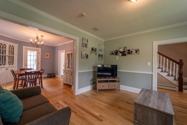 1349 Main St, Holden, MA 01520 - living room featuring a chandelier, ornamental molding, stairway, light wood-style floors, and baseboards