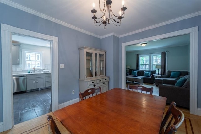 1349 Main St, Holden, MA 01520 - dining area featuring a chandelier, crown molding, baseboards, and light wood-type flooring