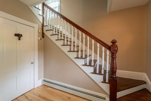 1349 Main St, Holden, MA 01520 - stairway with a baseboard heating unit, wood finished floors, and baseboards