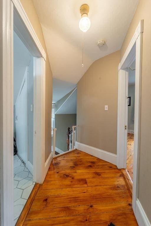 1349 Main St, Holden, MA 01520 - hallway featuring light wood-style floors, an upstairs landing, vaulted ceiling, and baseboards