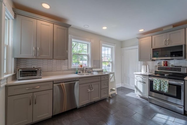 1349 Main St, Holden, MA 01520 - kitchen featuring stainless steel appliances, a sink, light countertops, backsplash, and gray cabinets