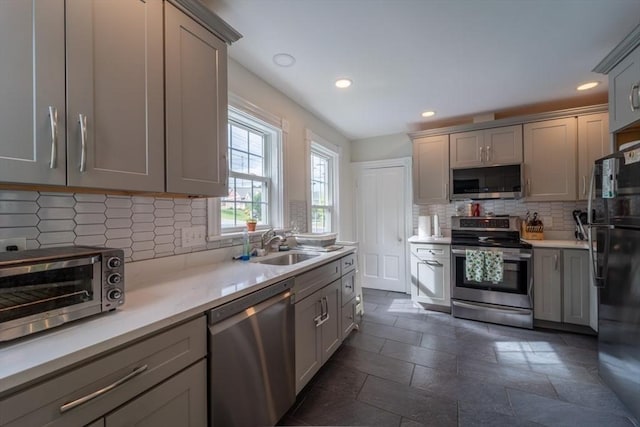 1349 Main St, Holden, MA 01520 - kitchen with stainless steel appliances, gray cabinets, decorative backsplash, light countertops, and recessed lighting