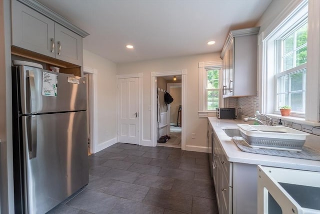 1349 Main St, Holden, MA 01520 - kitchen with freestanding refrigerator, plenty of natural light, light countertops, gray cabinetry, and recessed lighting