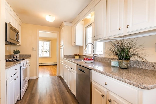 kitchen featuring a sink, plenty of natural light, a baseboard radiator, and stainless steel appliances