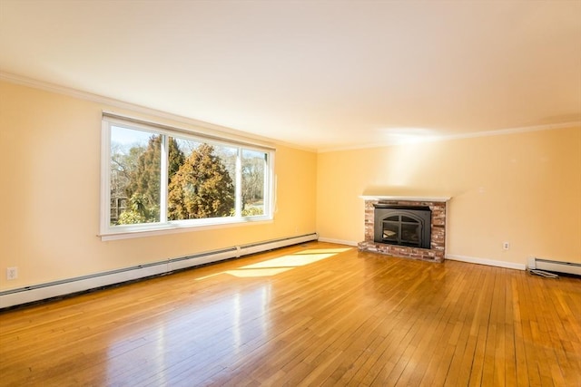 unfurnished living room with hardwood / wood-style flooring, crown molding, a fireplace, baseboards, and baseboard heating