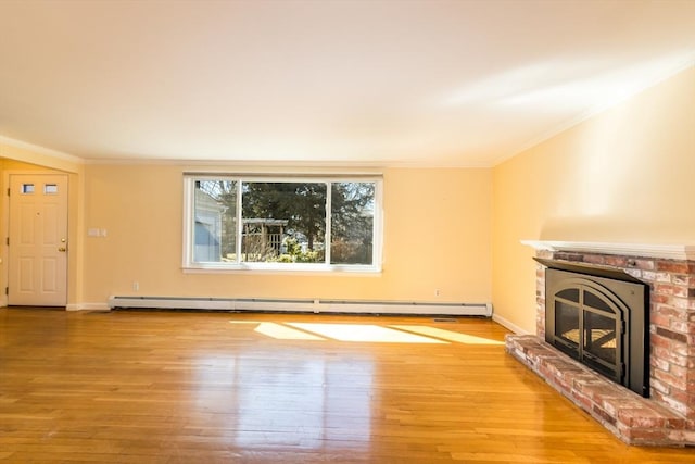 unfurnished living room featuring wood finished floors, baseboards, a fireplace, ornamental molding, and baseboard heating