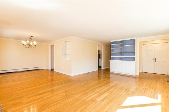 unfurnished room featuring light wood-style flooring, a baseboard heating unit, crown molding, baseboards, and a chandelier