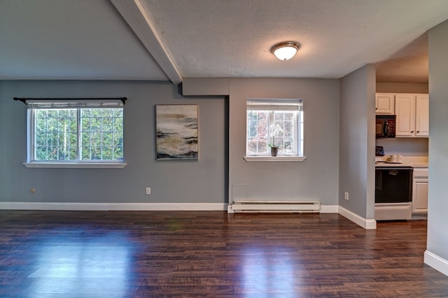 empty room with a baseboard heating unit, a textured ceiling, and dark hardwood / wood-style floors