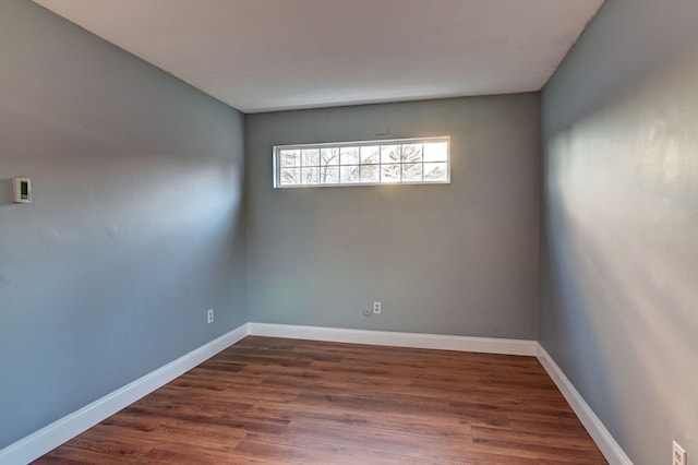 spare room with dark hardwood / wood-style floors