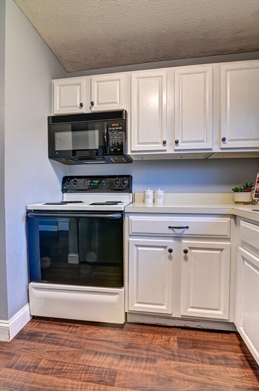 kitchen with white cabinets, dark wood-type flooring, a textured ceiling, and electric range