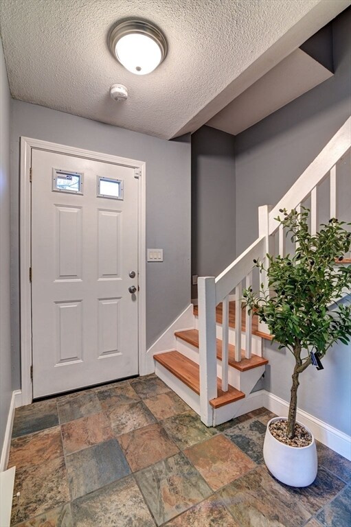 foyer entrance featuring a textured ceiling