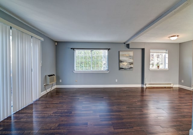 spare room with a baseboard heating unit, dark wood-type flooring, and a wall mounted air conditioner