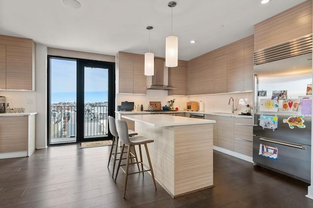 14 W Broadway Unit 903, Boston, MA 02127 - kitchen with built in refrigerator, modern cabinets, wall chimney exhaust hood, a kitchen breakfast bar, and dark wood-style floors
