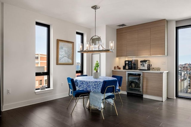 14 W Broadway Unit 903, Boston, MA 02127 - dining area featuring wine cooler, dark wood-style floors, baseboards, and bar area