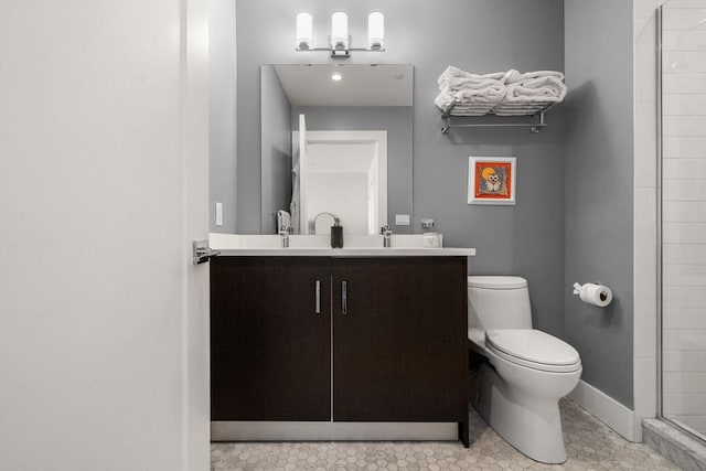 14 W Broadway Unit 903, Boston, MA 02127 - bathroom featuring toilet, double vanity, baseboards, and a shower