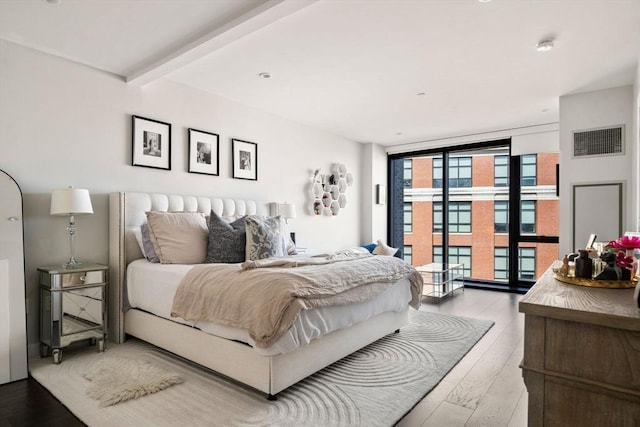 14 W Broadway Unit 903, Boston, MA 02127 - bedroom featuring expansive windows, access to exterior, and wood finished floors