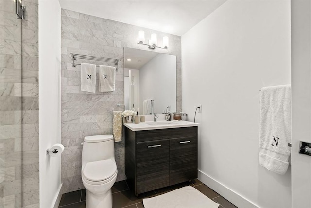 14 W Broadway Unit 903, Boston, MA 02127 - bathroom with vanity, tile patterned floors, toilet, tile walls, and a shower with door