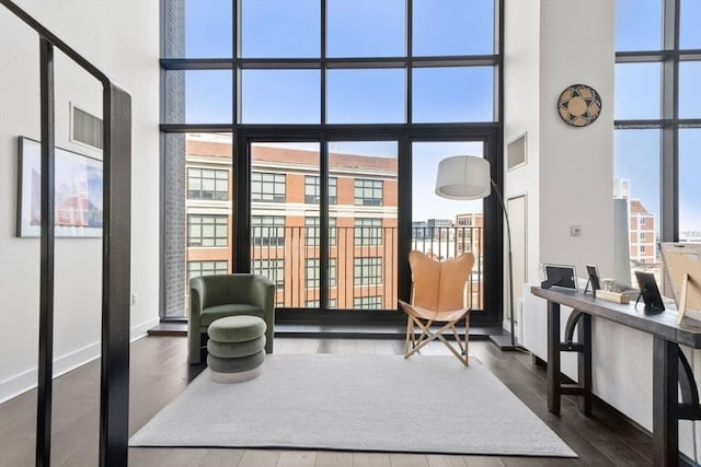 14 W Broadway Unit 903, Boston, MA 02127 - living area with a high ceiling, plenty of natural light, dark wood-type flooring, baseboards, and floor to ceiling windows