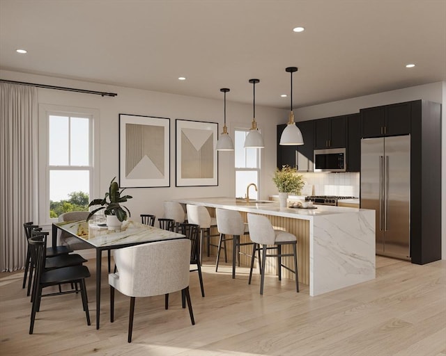 dining area with light hardwood / wood-style flooring and sink