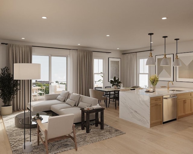 living room featuring light wood-type flooring, a wealth of natural light, and sink