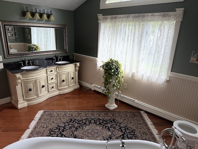 3 Wolf Rd, Bourne, MA 02532 - full bathroom featuring a wainscoted wall, double vanity, wood finished floors, and vaulted ceiling