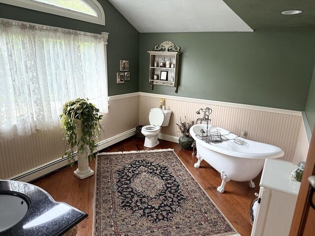 3 Wolf Rd, Bourne, MA 02532 - bathroom with wainscoting, a soaking tub, wood finished floors, vanity, and vaulted ceiling
