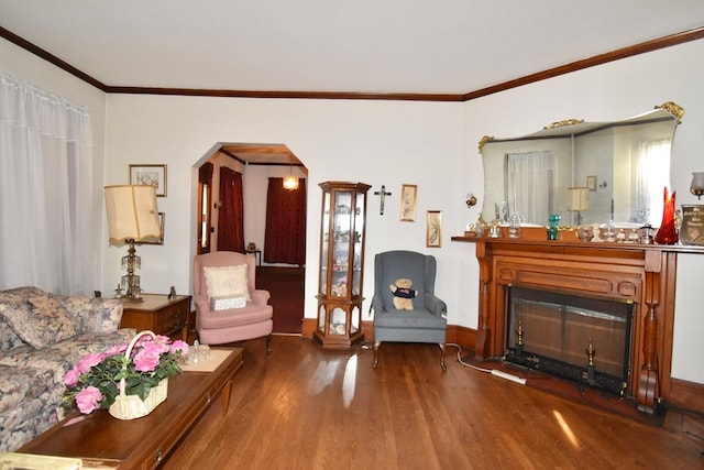 living area with crown molding and hardwood / wood-style floors