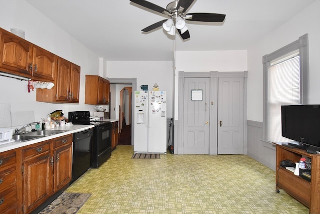 kitchen with black appliances, sink, and ceiling fan