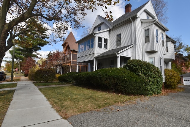 view of side of home with a yard