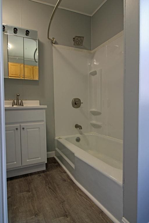 full bathroom featuring shower / bath combination, wood finished floors, vanity, and baseboards