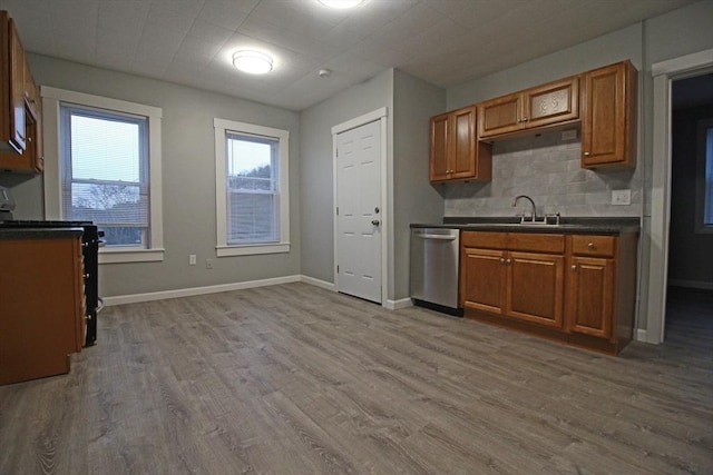kitchen with brown cabinets, wood finished floors, and dishwasher