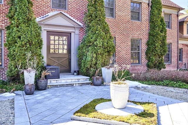 view of exterior entry with brick siding