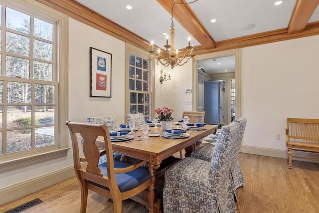 dining room featuring visible vents, baseboards, an inviting chandelier, light wood-style floors, and beamed ceiling