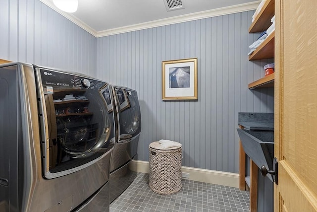 laundry area with tile patterned floors, visible vents, ornamental molding, washing machine and dryer, and laundry area