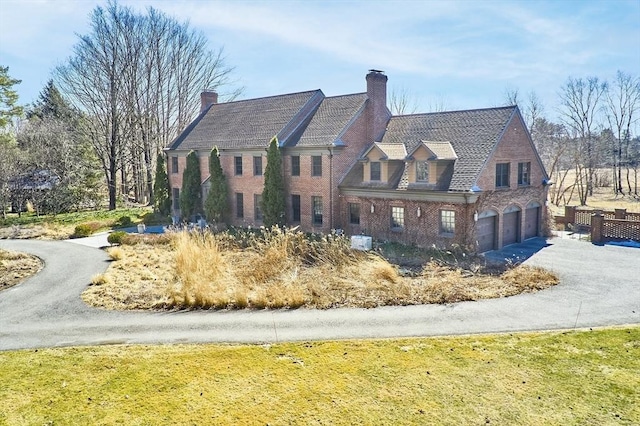 view of front facade featuring a garage, brick siding, and driveway