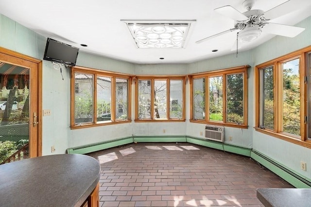 unfurnished sunroom with brick flooring, plenty of natural light, and a wall mounted AC