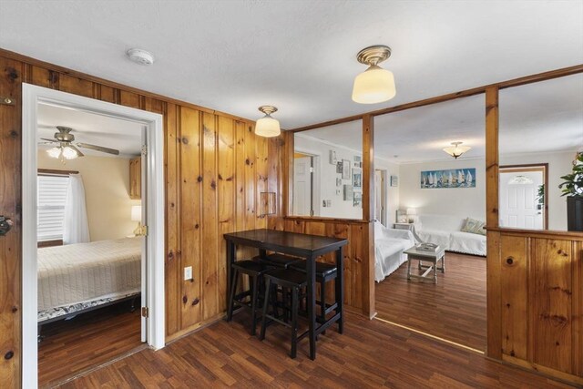 34 13th St, Wareham, MA 02532 - dining room with wood finished floors, wooden walls, crown molding, and a ceiling fan