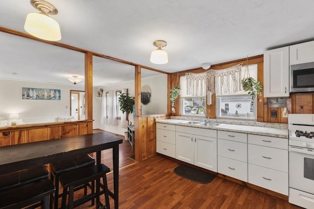 34 13th St, Wareham, MA 02532 - kitchen featuring stainless steel microwave, a sink, white gas range oven, and white cabinets