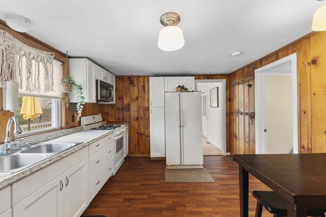 34 13th St, Wareham, MA 02532 - kitchen featuring white appliances, a sink, light countertops, dark wood-style flooring, and wooden walls