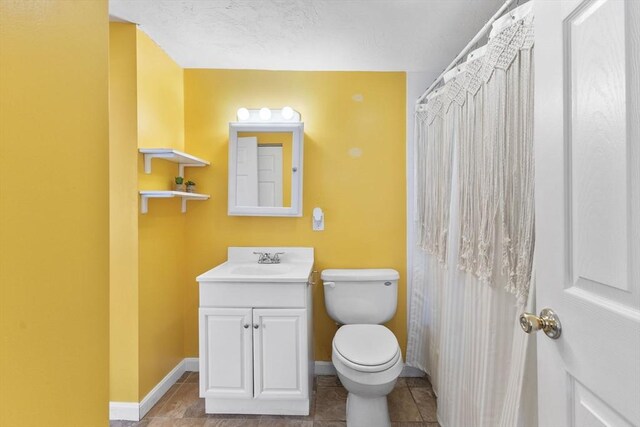34 13th St, Wareham, MA 02532 - bathroom with toilet, baseboards, vanity, and tile patterned floors