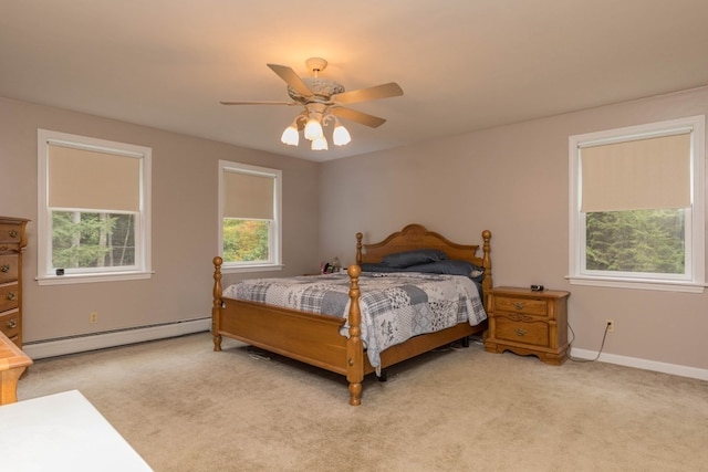 bedroom with ceiling fan, light colored carpet, and a baseboard radiator